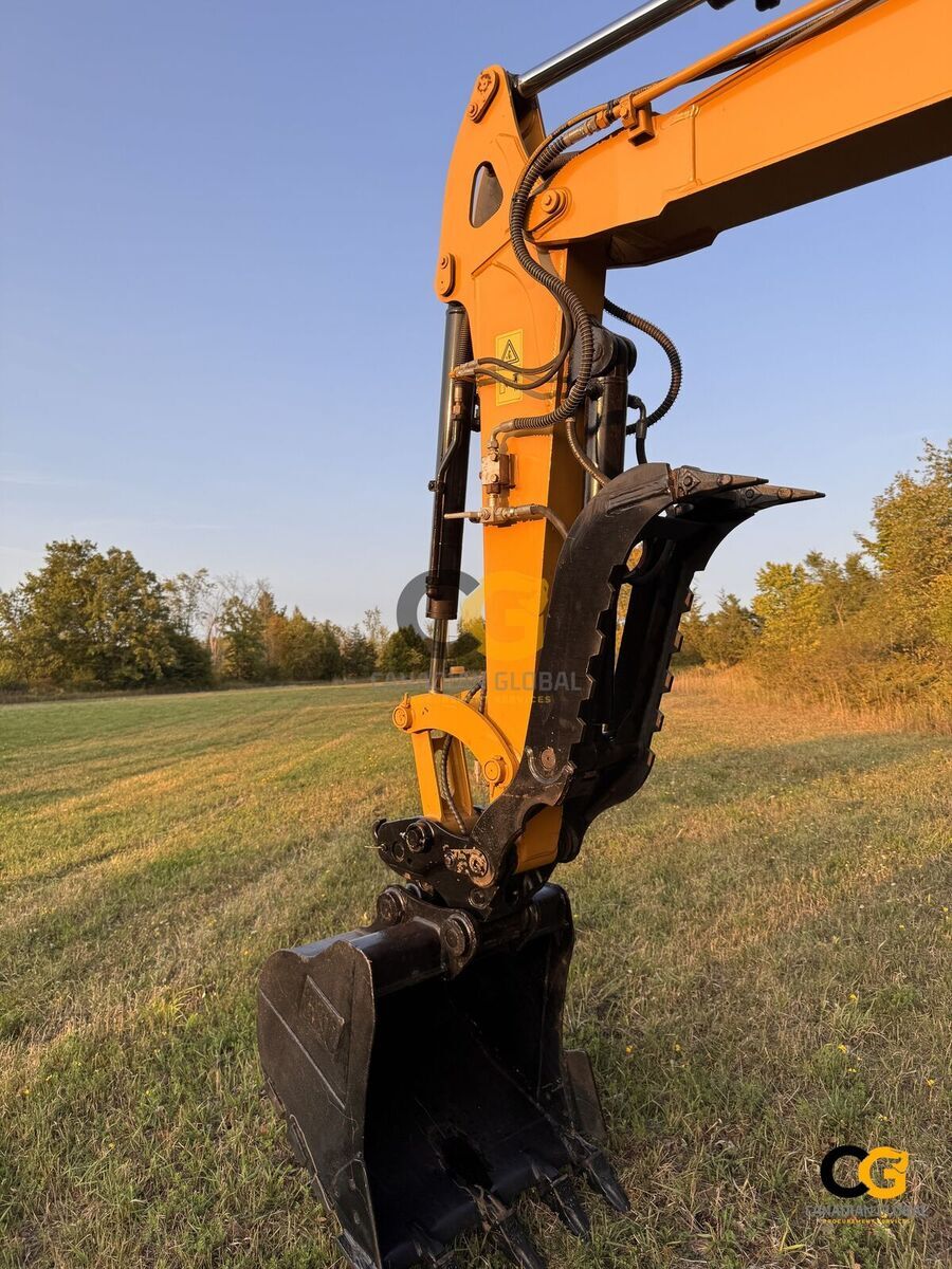 Standard digging bucket and hydraulic thumb — included with every machine