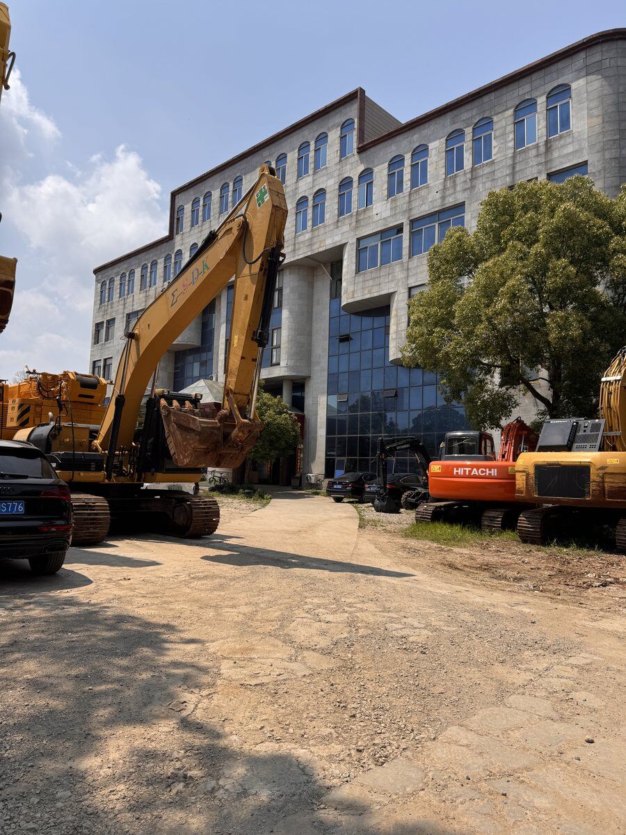 Large Komatsu excavator at the sourcing facility office