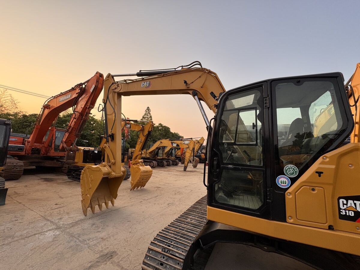 CAT 310 mini excavator ready for inspection at the facility