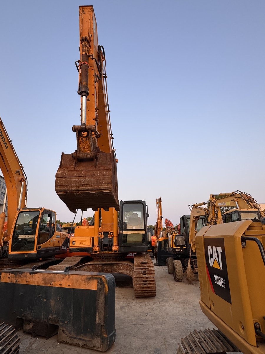 Dramatic shot of excavator booms against the sky