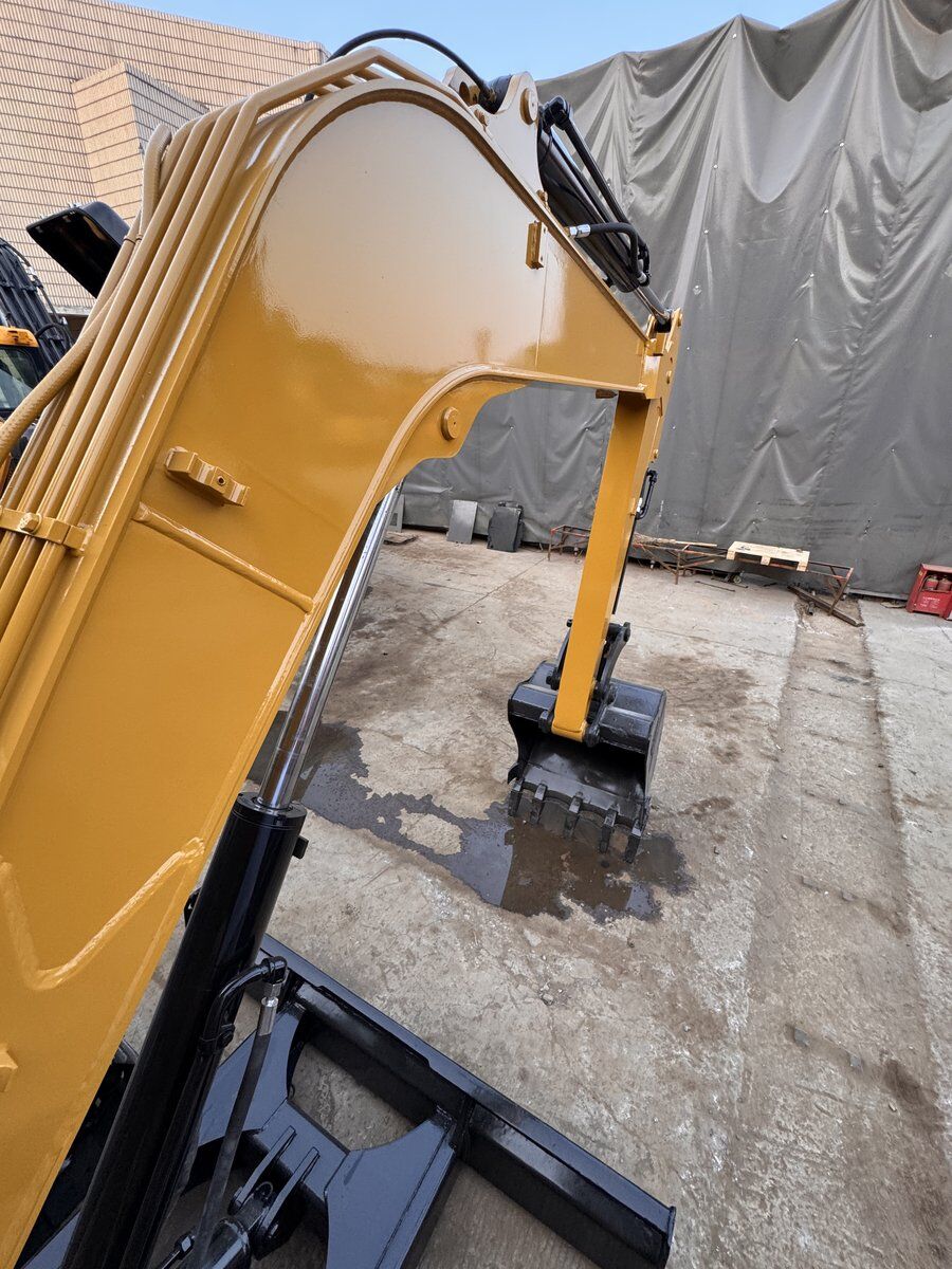 Close-up of freshly painted excavator boom — refurbishment in progress