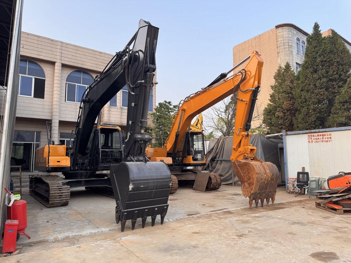 Refurbished excavators parked in front of facility buildings
